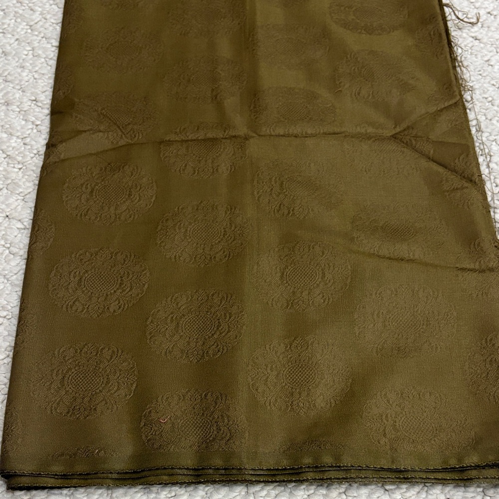 Elegant dark Olive Green material. Has a little sheet to it. Self design pattern